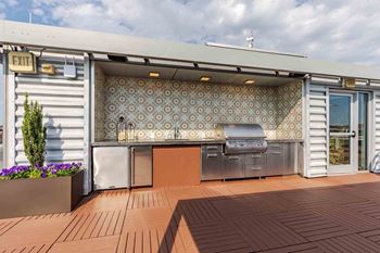 Modern outdoor bar and kitchen with gas grills for gatherings