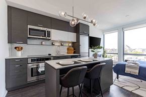 Washington apartment for rent - A modern kitchen with a dining table and chairs.