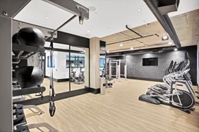 Portland apartment for rent - A gym with a variety of exercise equipment including treadmills, weights, and exercise machines.