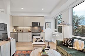 Portland apartment for rent - A modern kitchen with a dining table and a couch.