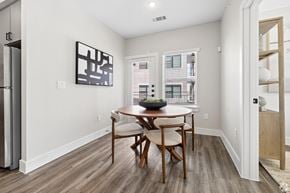 Spring apartment for rent - A dining room with a wooden table and chairs.
