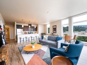 Issaquah apartment for rent - A living room with a blue chair and a brown table.