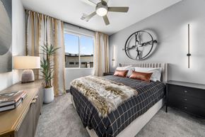 Tempe apartment for rent - A bedroom with a large bed and a ceiling fan.