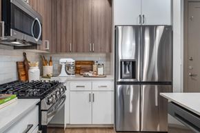 Tempe apartment for rent - A modern kitchen with a stainless steel refrigerator and white appliances.