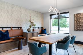 Lewisville apartment for rent - A dining room with a wooden table and blue chairs.