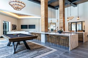 Lewisville apartment for rent - A pool table is in the middle of a room with a bar.