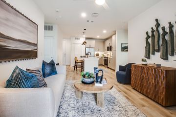 Plano apartment for rent - A living room with a white couch and a wooden coffee table.