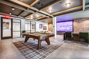 Plano apartment for rent - A room with a pool table and a bar area.