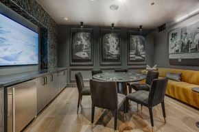 Plano apartment for rent - A modern dining room with a glass table and chairs.