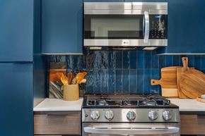 Phoenix apartment for rent - A modern kitchen with a stove, oven, and a microwave mounted above the stove.