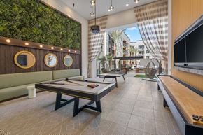 Phoenix apartment for rent - A room with a green wall and a pool table.