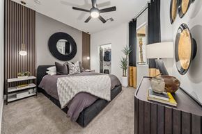 Phoenix apartment for rent - A bedroom with a large bed and a ceiling fan.