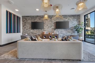 O Fallon apartment for rent - A modern living room with a grey sofa and a stone wall.