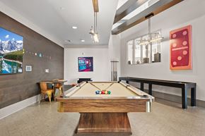 Phoenix apartment for rent - A pool table is in the middle of a room with a billiard table light.