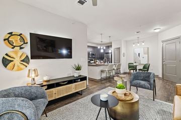 San Antonio apartment for rent - A living room with a blue chair and a gold side table.