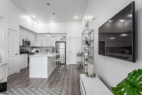 Bluffdale apartment for rent - A modern kitchen with white cabinets and a large island.