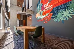Seattle apartment for rent - a dining area with a table and chairs and a mural on the wall