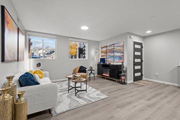 Salt Lake City apartment for rent - A living room with a white couch and a fireplace.