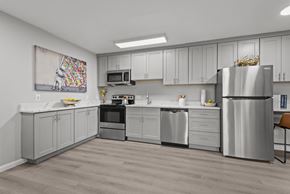 Salt Lake City apartment for rent - A modern kitchen with a refrigerator, oven, and microwave.