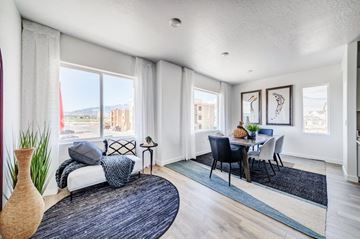 Pleasant Grove apartment for rent - A living room with a white sofa and a black chair.