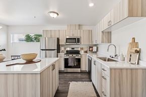 Richland apartment for rent - A modern kitchen with wooden cabinets and stainless steel appliances.