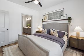 Melissa apartment for rent - A bedroom with a large bed and a ceiling fan.