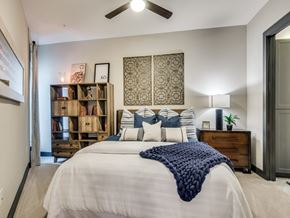 Dallas apartment for rent - the retreat at thousand oaks apartment bedroom with ceiling fan and bookshelf