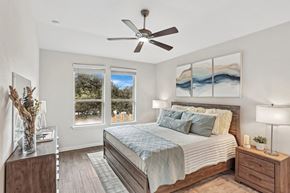 Austin apartment for rent - A bedroom with a bed, nightstands, and a ceiling fan.