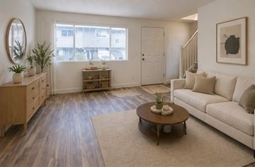 Vancouver apartment for rent - A living room with a white couch and a wooden coffee table.