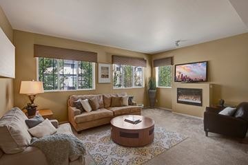 Puyallup apartment for rent - A living room with a couch, coffee table, and a painting on the wall.