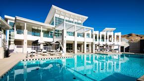 Bluffdale apartment for rent - A large swimming pool in front of a modern building.