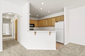 Medford apartment for rent - a kitchen with white walls and brown cabinets