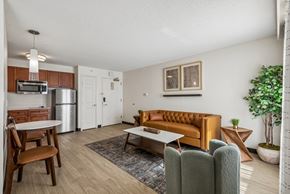 Houston apartment for rent - A living room with a brown sofa and a wooden table.