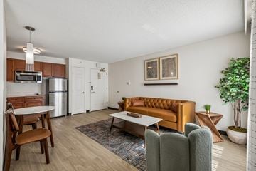 Houston apartment for rent - A living room with a brown sofa and a wooden table.