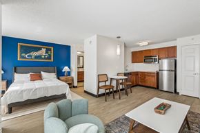 Houston apartment for rent - A bedroom with a blue wall and a white bed.