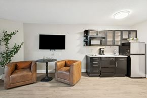 Houston apartment for rent - A living room with a brown chair and a black TV.