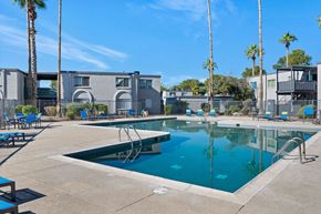 Tucson apartment for rent - A swimming pool with a slide in the middle of it.