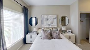Orem apartment for rent - a bedroom with white bedding and two white chests of drawers
