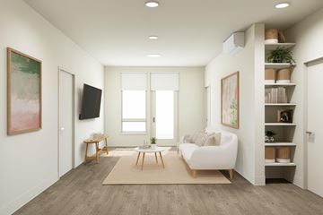 Bend apartment for rent - A living room with a white sofa, wooden coffee table, and a painting on the wall.