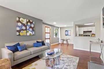 Beaverton apartment for rent - A living room with a couch, coffee table, and a painting on the wall.
