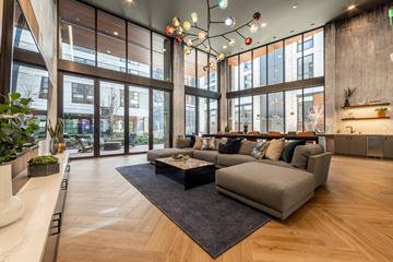 Seattle apartment for rent - A modern living room with a large couch and a coffee table.