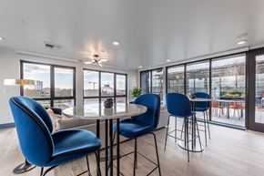 Seattle apartment for rent - A dining area with blue chairs and a table.