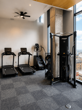 Kansas City apartment for rent - A gym with treadmills, weights and a fan.