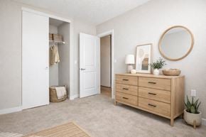 Richland apartment for rent - A room with a white door, a white cabinet, and a round mirror on the wall.