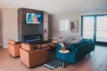Gretna apartment for rent - A living room with a television on the wall and a fireplace.