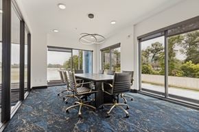 Spring apartment for rent - A conference room with a table and chairs and a view of the outside.