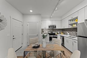 Spokane apartment for rent - A modern kitchen with a dining table set for two.