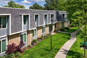 Murray apartment for rent - A long building with a green lawn in front.
