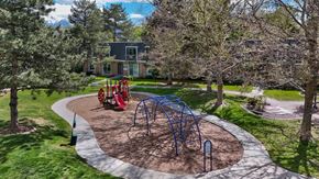 Murray apartment for rent - A playground with a blue swing set and red slide.