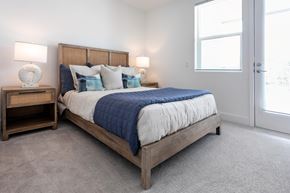 Irvine apartment for rent - A bedroom with a large bed and two lamps on side tables.